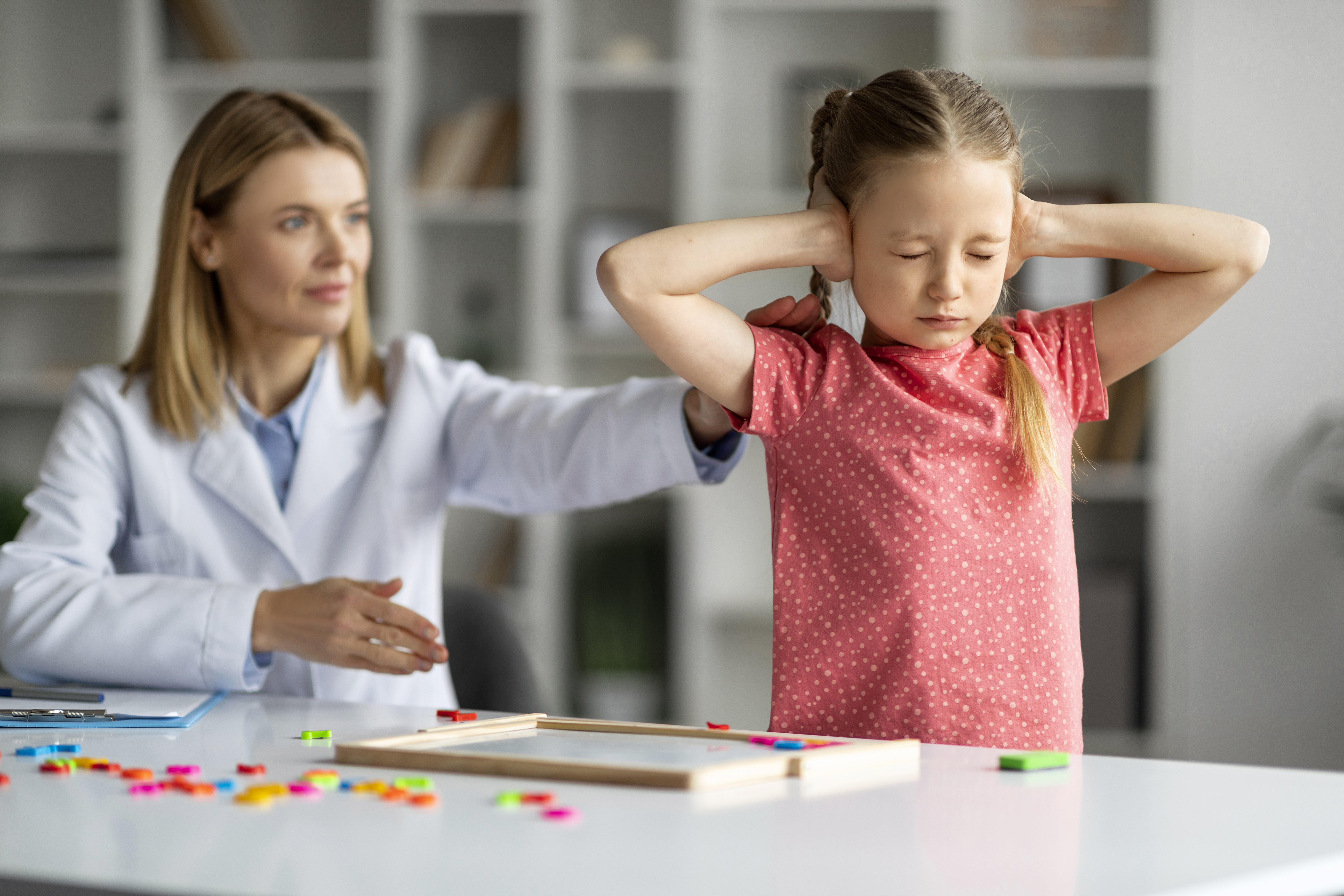 Professional Psychotherapist Lady Trying To Talk To Difficult Kid At Therapy Session
