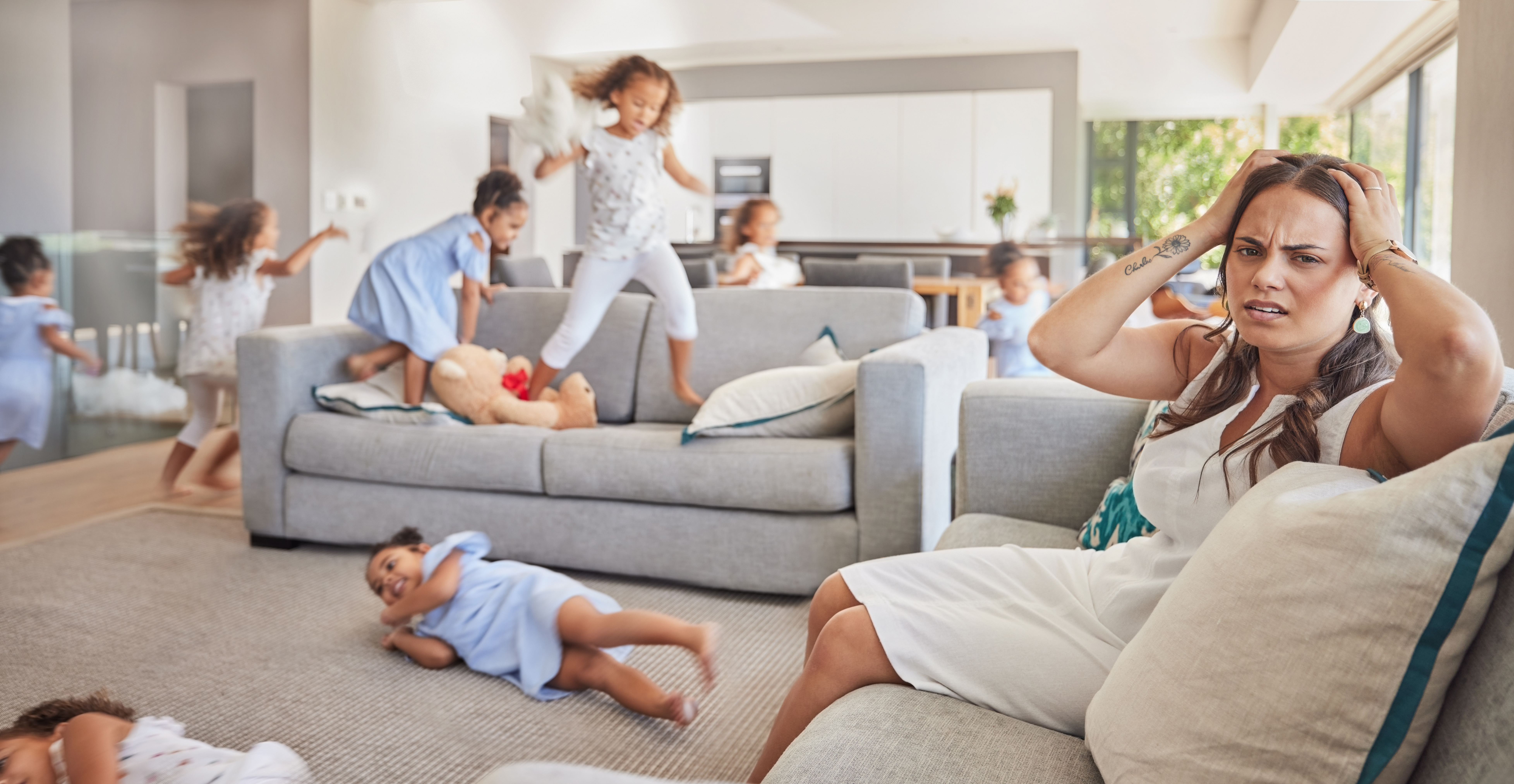 Stress, headache and mother with adhd kids running, jumping and playing in family home or house liv